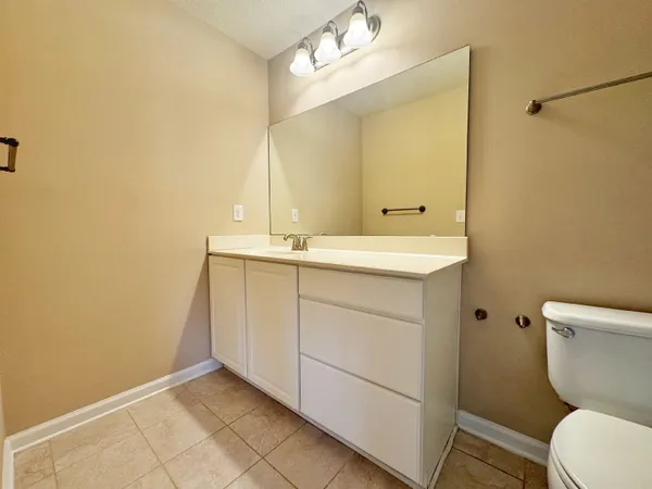 a bathroom with a sink a toilet and mirror