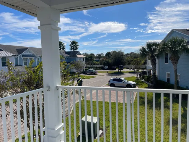 a view of balcony with wooden floor and fence