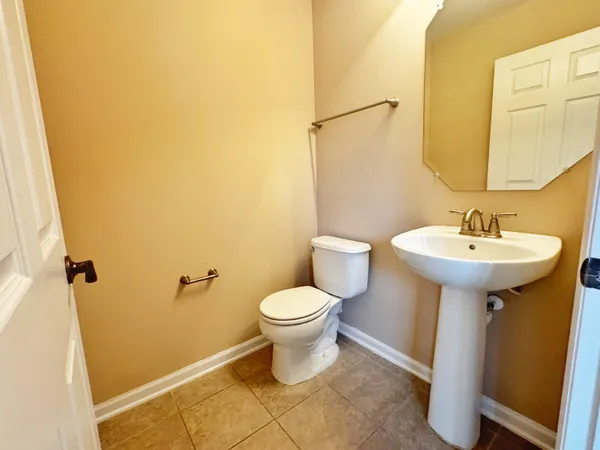 a bathroom with a sink toilet and a mirror