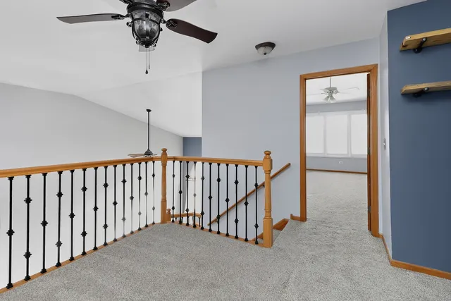 a spacious bedroom with a bed and a chandelier