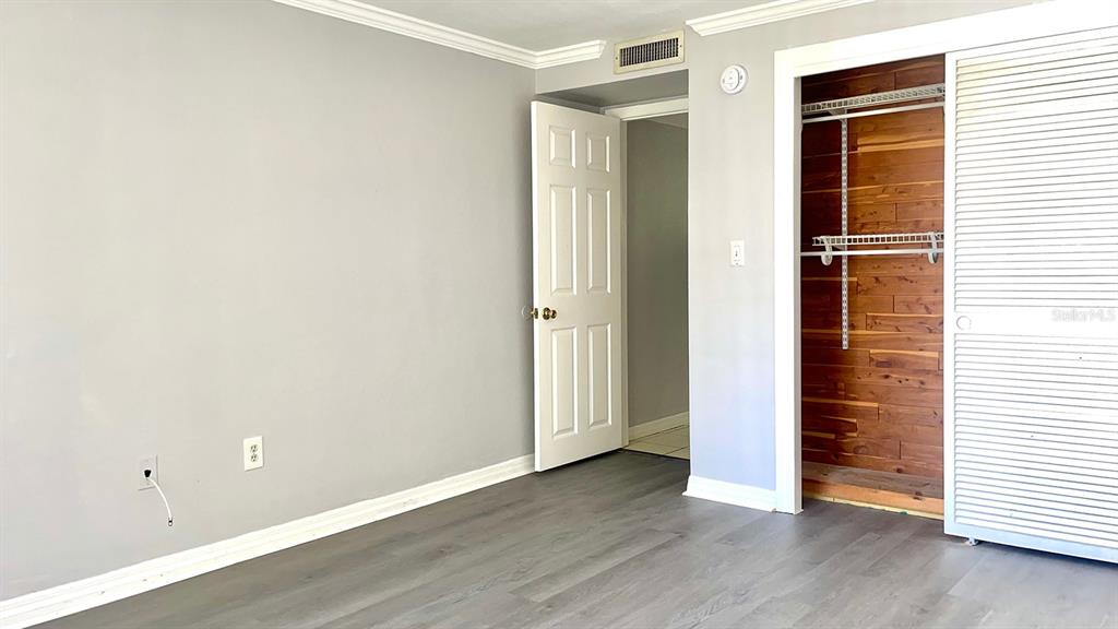 4211 Sheldon Place, Unit 4211 New Port Richey, FL 34652 - Photo 12 of 58 an empty room with wooden floor and windows