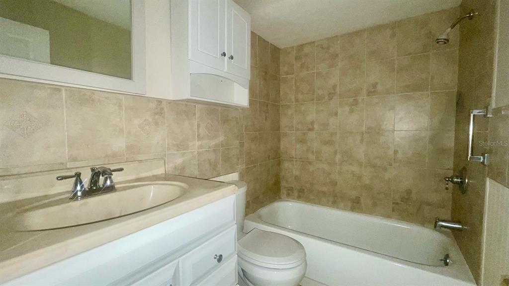 4211 Sheldon Place, Unit 4211 New Port Richey, FL 34652 - Photo 16 of 58 a bathroom with a sink a toilet and shower