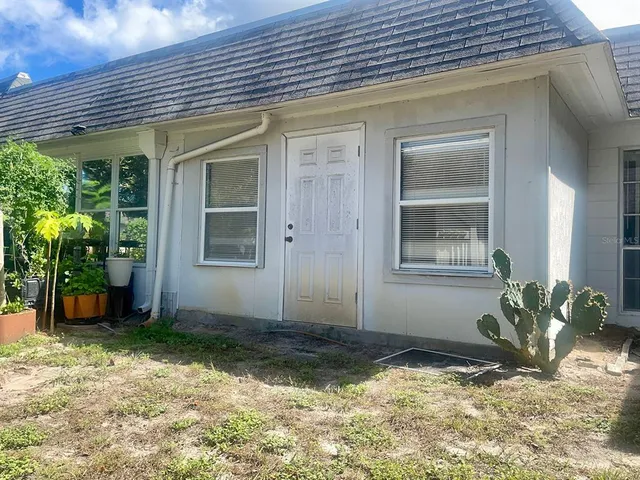 a view of a house with a backyard