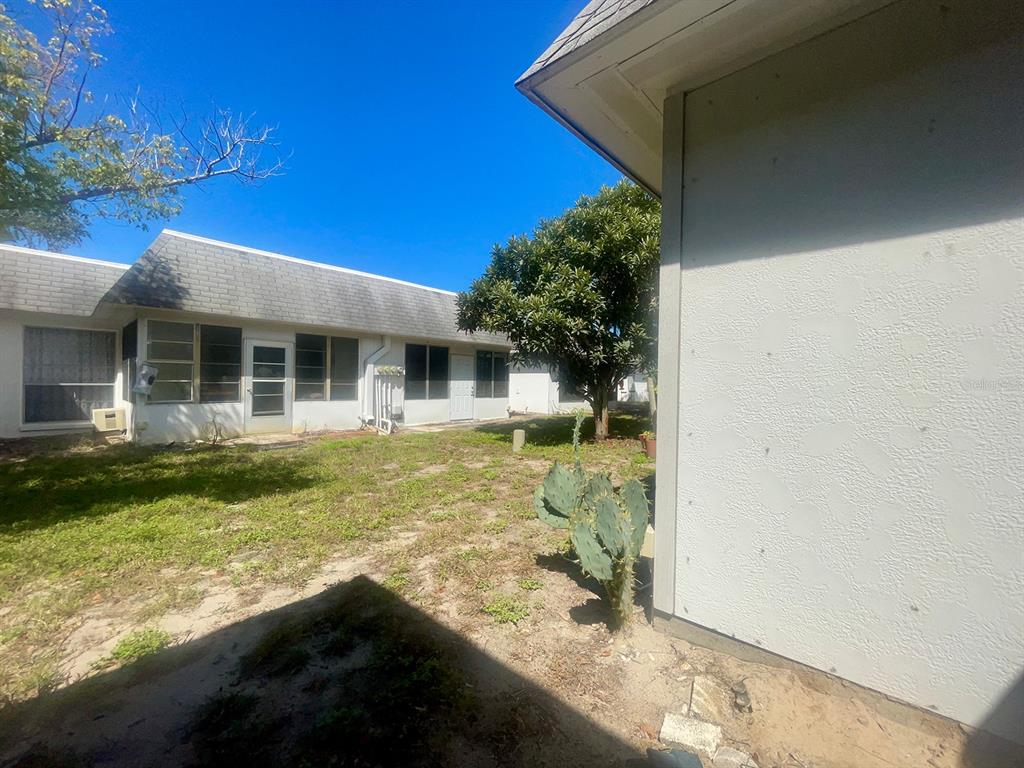 4211 Sheldon Place, Unit 4211 New Port Richey, FL 34652 - Photo 20 of 58 a view of a house with a backyard