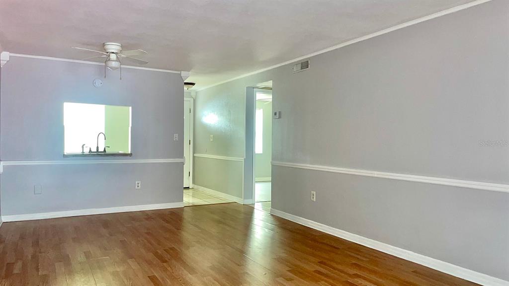 4211 Sheldon Place, Unit 4211 New Port Richey, FL 34652 - Photo 2 of 58 an empty room with wooden floor and windows