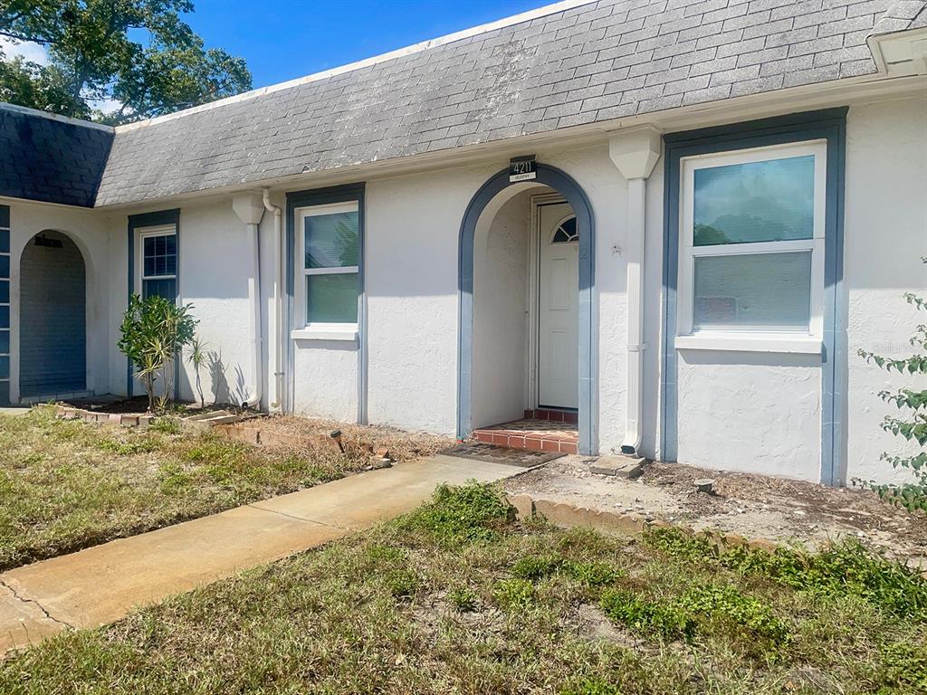4211 Sheldon Place, Unit 4211 New Port Richey, FL 34652 - Photo 22 of 58 a front view of a house with a yard
