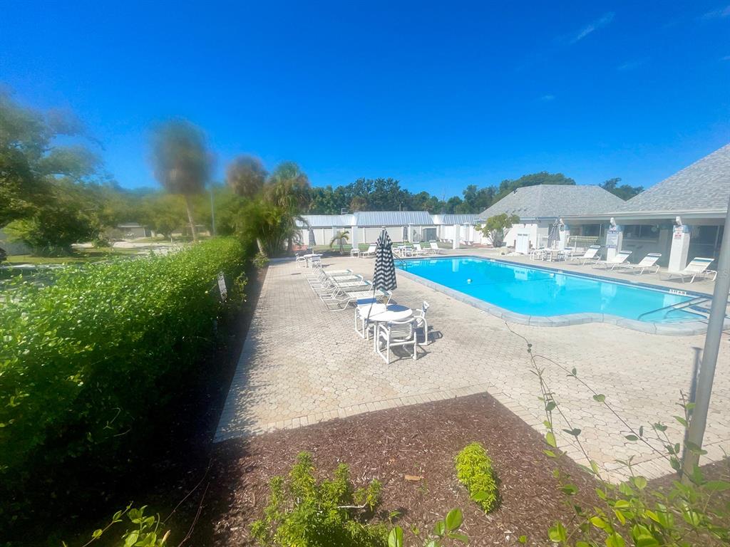 4211 Sheldon Place, Unit 4211 New Port Richey, FL 34652 - Photo 32 of 58 a view of a lake with a house in the background