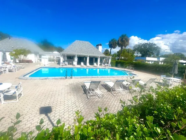 a utility room with stainless steel appliances wooden cabinet and stove top oven