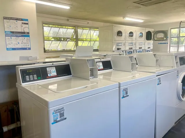 a view of a kitchen with fridge and wooden floor