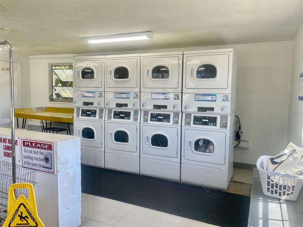 4211 Sheldon Place, Unit 4211 New Port Richey, FL 34652 - Photo 39 of 58 a utility room with stainless steel appliances wooden cabinet and stove top oven