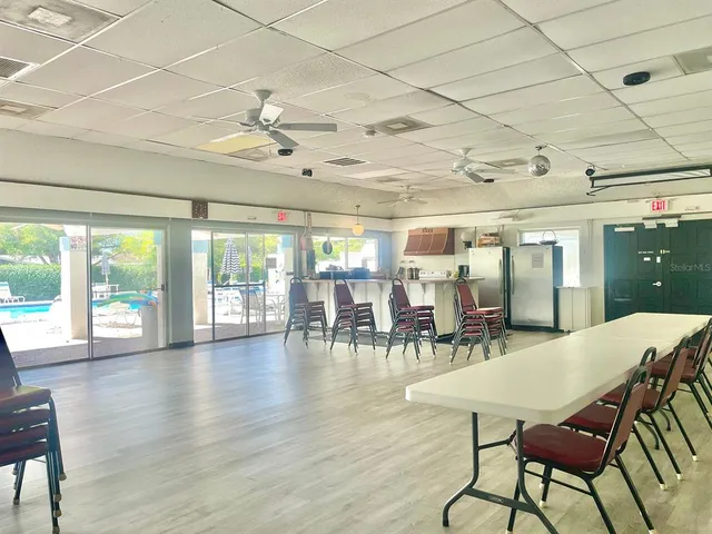 a view of a house with swimming pool and sitting area
