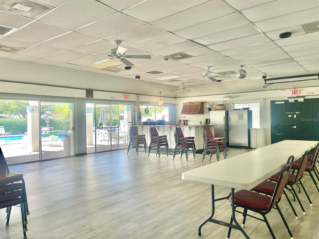 4211 Sheldon Place, Unit 4211 New Port Richey, FL 34652 - Photo 48 of 58 a view of a dining room with furniture wooden floor and chandelier