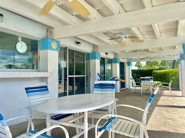 a view of house with swimming pool and a yard