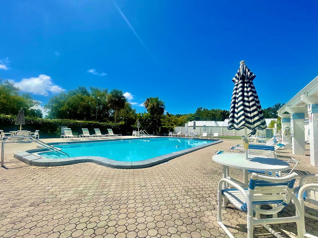 4211 Sheldon Place, Unit 4211 New Port Richey, FL 34652 - Photo 51 of 58 a view of a swimming pool with lounge chairs