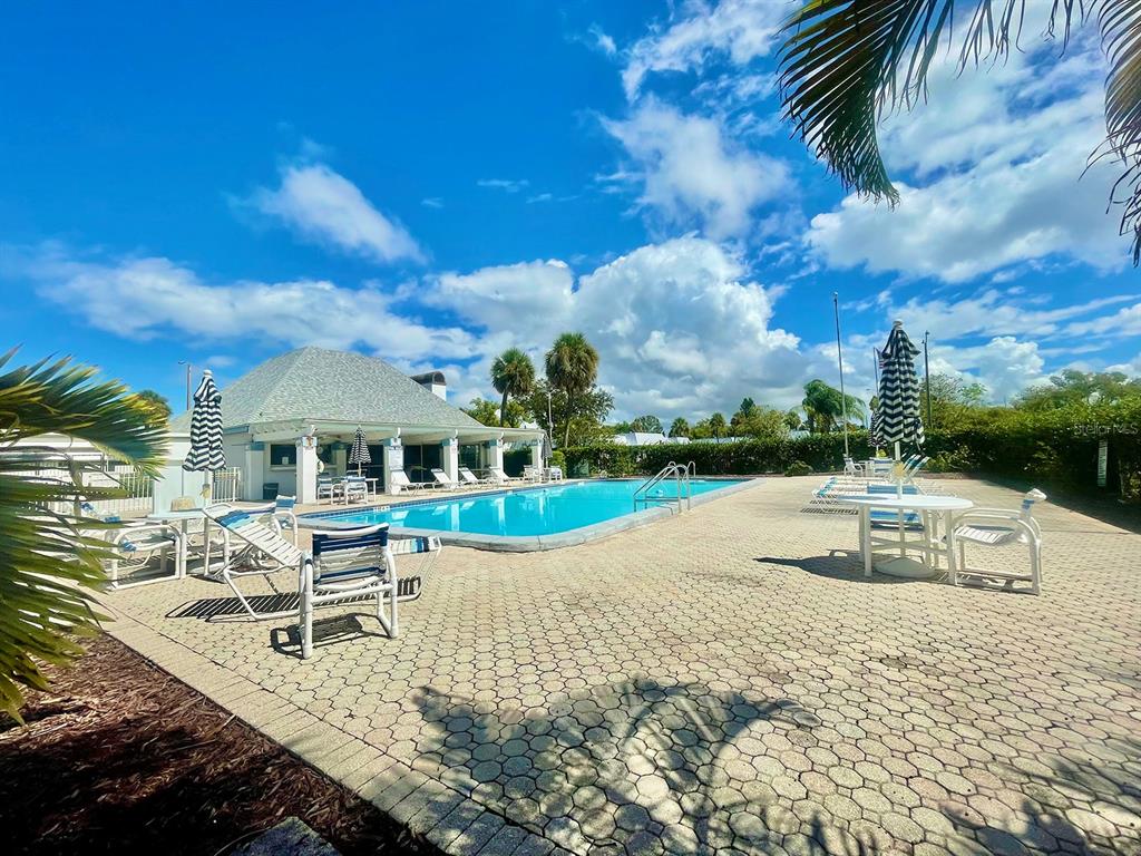 4211 Sheldon Place, Unit 4211 New Port Richey, FL 34652 - Photo 56 of 58 a view of a house with swimming pool and sitting area