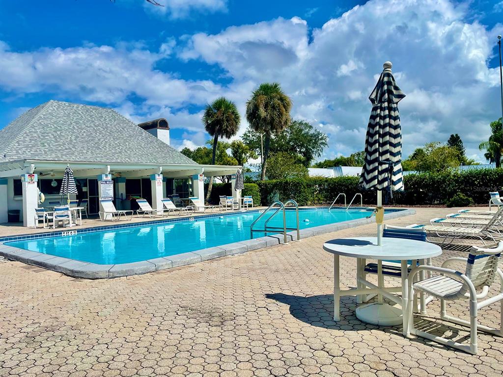 4211 Sheldon Place, Unit 4211 New Port Richey, FL 34652 - Photo 57 of 58 a view of house with swimming pool and a yard