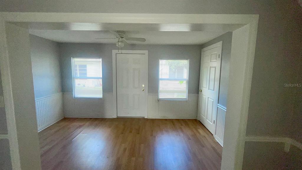 4211 Sheldon Place, Unit 4211 New Port Richey, FL 34652 - Photo 6 of 58 an empty room with wooden floor and windows