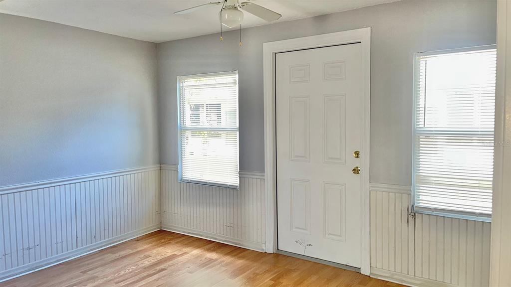 4211 Sheldon Place, Unit 4211 New Port Richey, FL 34652 - Photo 7 of 58 a view of an empty room with wooden floor and a window