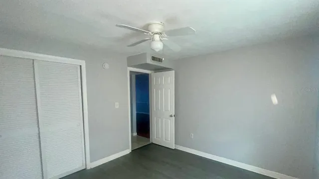 an empty room with a fan and a ceiling fan