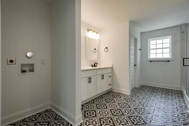 a bathroom with a sink a toilet and a window