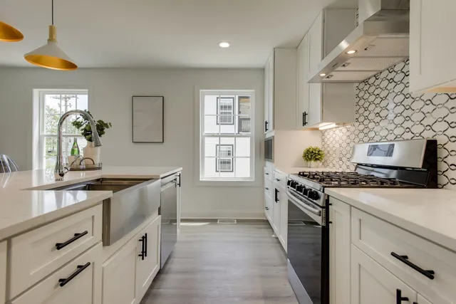 a kitchen with granite countertop a stove and a sink
