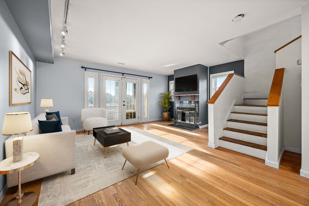 36 Cummings Road, Unit 10 Boston, MA 02135 - Photo 1 of 17 a large bedroom with furniture and wooden floor