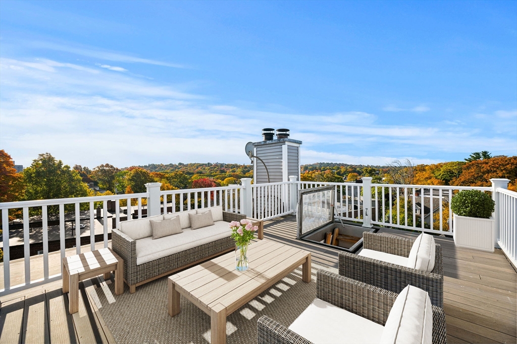 36 Cummings Road, Unit 10 Boston, MA 02135 - Photo 3 of 17 a view of a patio with couches chairs and wooden floor