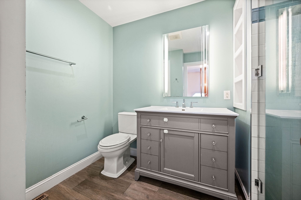 36 Cummings Road, Unit 10 Boston, MA 02135 - Photo 6 of 17 a bathroom with a toilet sink and mirror
