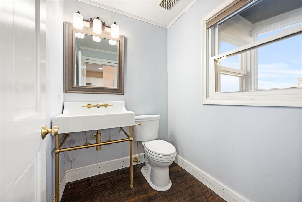 36 Cummings Road, Unit 10 Boston, MA 02135 - Photo 7 of 17 a bathroom with a sink a toilet and mirror