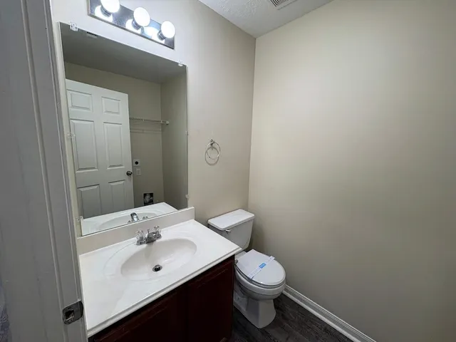 a bathroom with a sink a toilet and mirror