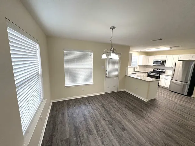 a view of a kitchen with stove and cabinets