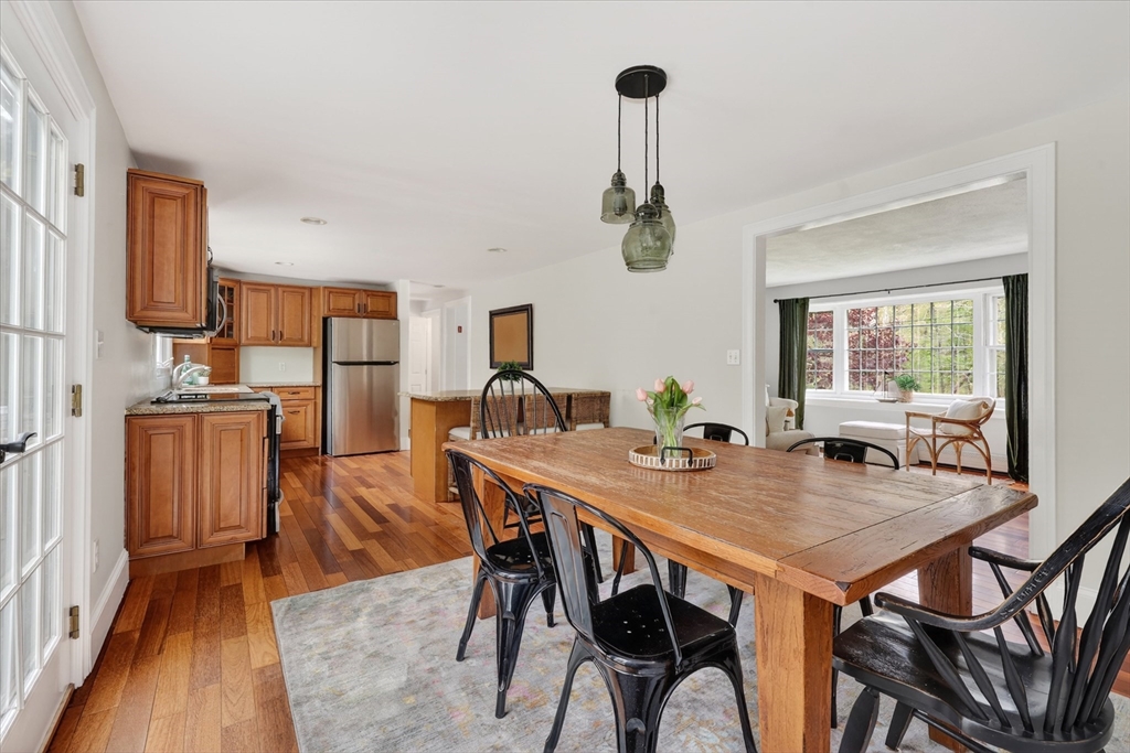 59 First Parish Road Norwell, MA 02061 - Photo 9 of 37 a view of a dining room and livingroom with furniture wooden floor a chandelier