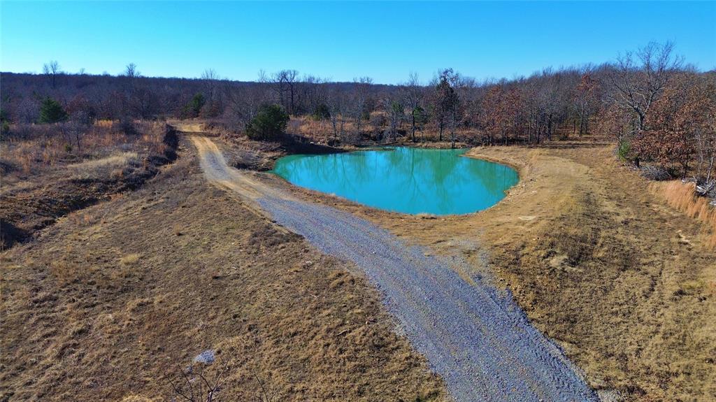 0 N3840 Road Coalgate, OK 74538 - Photo 11 of 35 a view of a swimming pool with a yard and mountain view