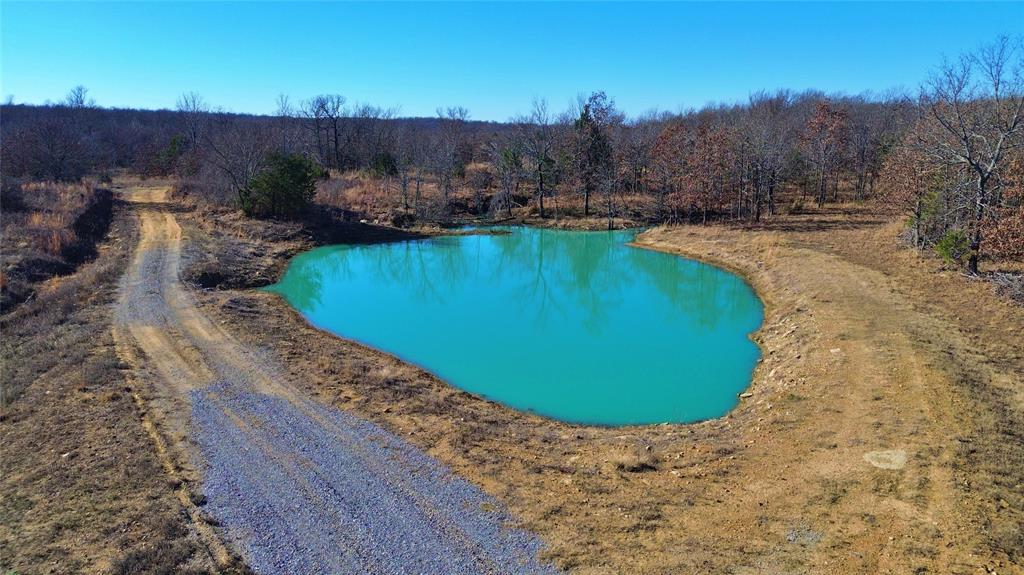 0 N3840 Road Coalgate, OK 74538 - Photo 5 of 40 a view of a swimming pool with a yard and mountain view