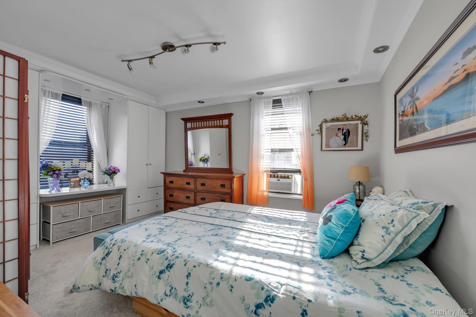 83-25 98th Street, Unit 4L Queens, NY 11421 - Photo 12 of 14 Carpeted bedroom with multiple windows