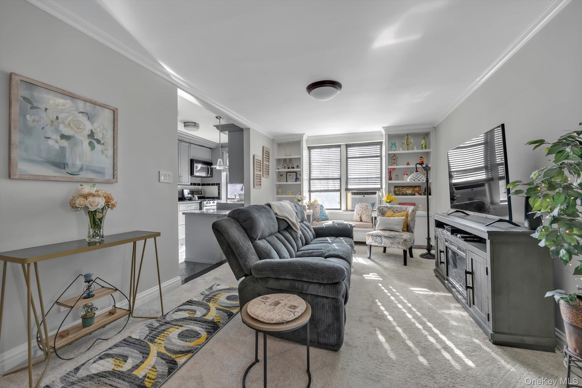 83-25 98th Street, Unit 4L Queens, NY 11421 - Photo 4 of 14 Living area featuring carpet flooring, crown molding, and built in features