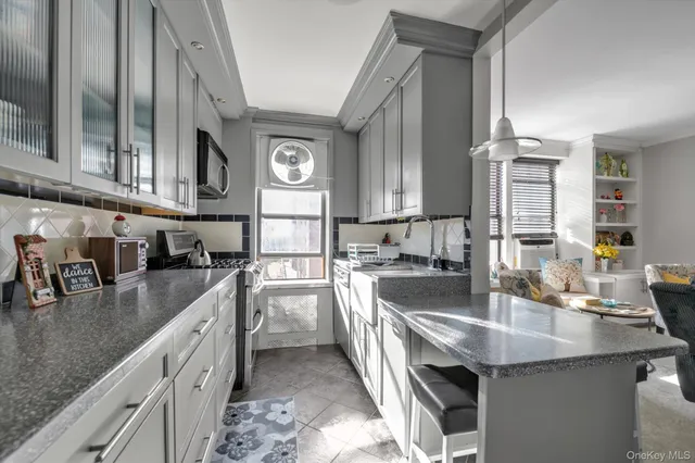 a kitchen with stainless steel appliances granite countertop a sink a stove and cabinets