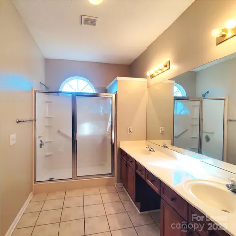 a bathroom with a double vanity sink and a mirror