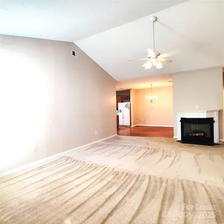 a view of empty room with a fireplace and fan