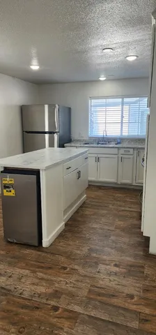 a kitchen with sink cabinets and window