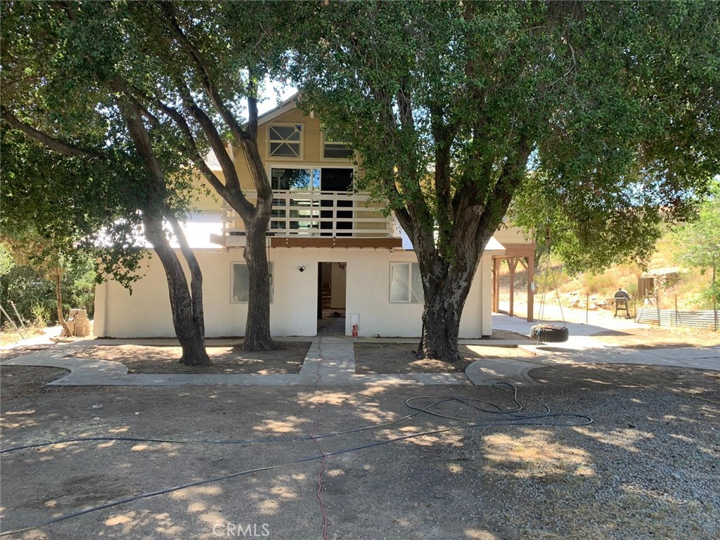 34930 East Benton Road Hemet, CA 92544 - Photo 3 of 54 a view of a trees in front of a house