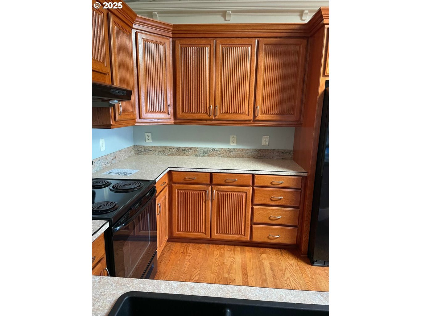 409 Evergreen Avenue Garibaldi, OR 97118 - Photo 31 of 48 a kitchen with granite countertop white cabinets and stainless steel appliances