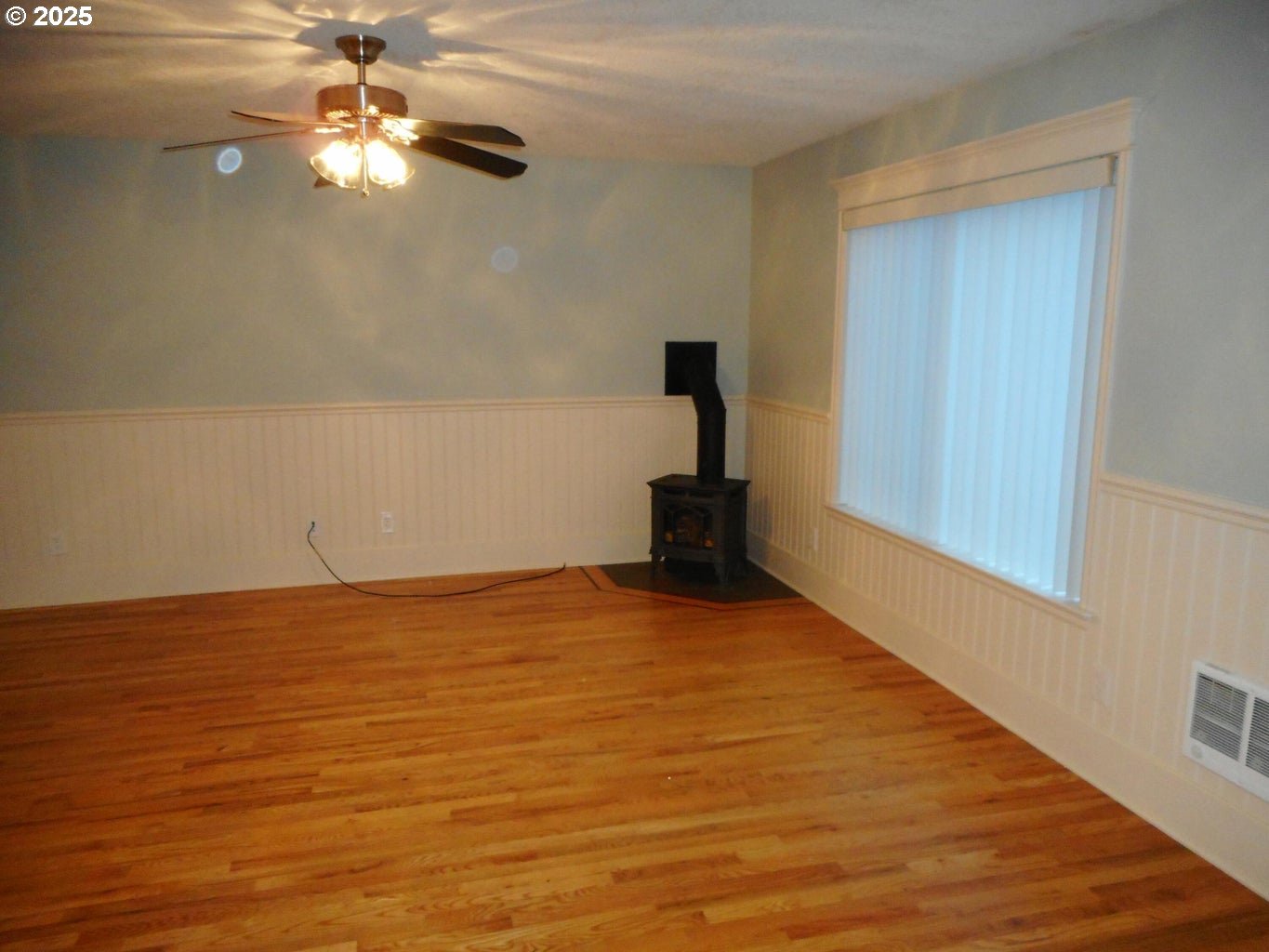 409 Evergreen Avenue Garibaldi, OR 97118 - Photo 43 of 48 a view of a room with an empty space a ceiling fan and wooden floor