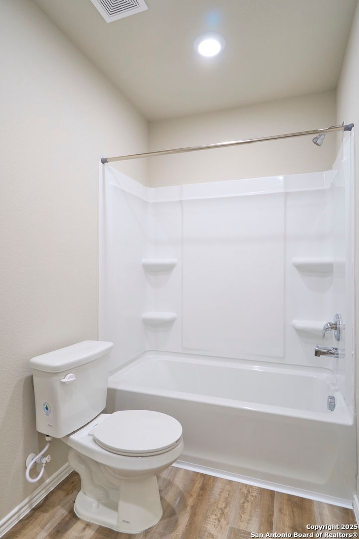 482 Abigail Alley San Antonio, TX 78253 - Photo 20 of 27 a bathroom with a toilet and a bathtub