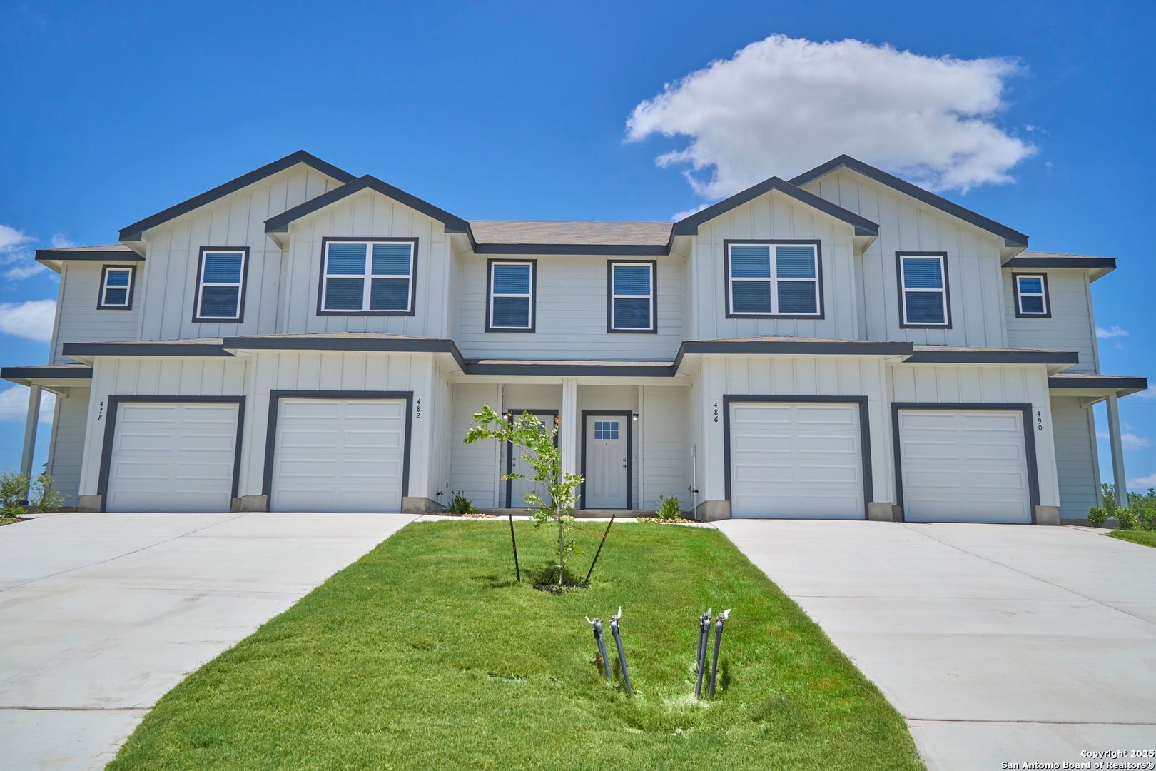 482 Abigail Alley San Antonio, TX 78253 - Photo 2 of 27 a front view of a house with a yard and garage