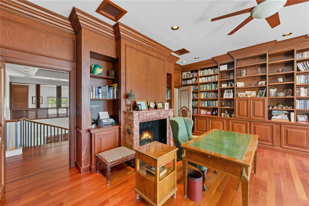 3315 Bay Shore Road Sarasota, FL 34234 - Photo 57 of 96 a living room with furniture wooden floor and a fireplace
