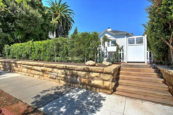 a view of a house with backyard and sitting area