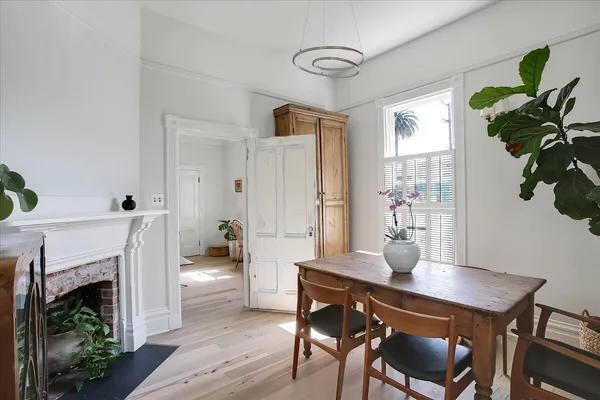 a view of a dining room with furniture and a fireplace