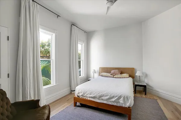 a spacious bedroom with a bed and a desk