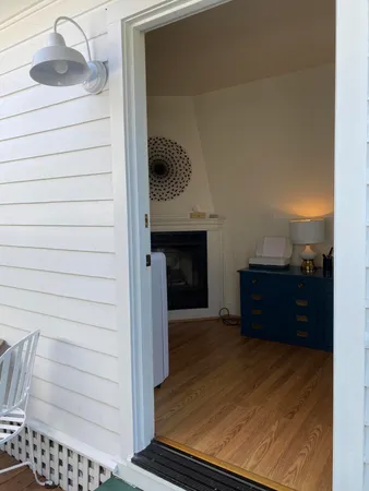 a wooden bench sitting in backside of a house